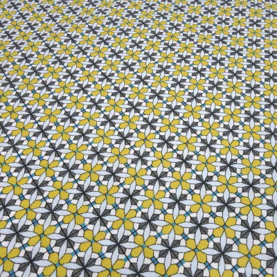 Fabric: cotton poplin with a graphic ornamental pattern flowers in curry yellow, blue, gray, white, and teal; suitable for dresses, children’s clothing, decorative items, and blouses
