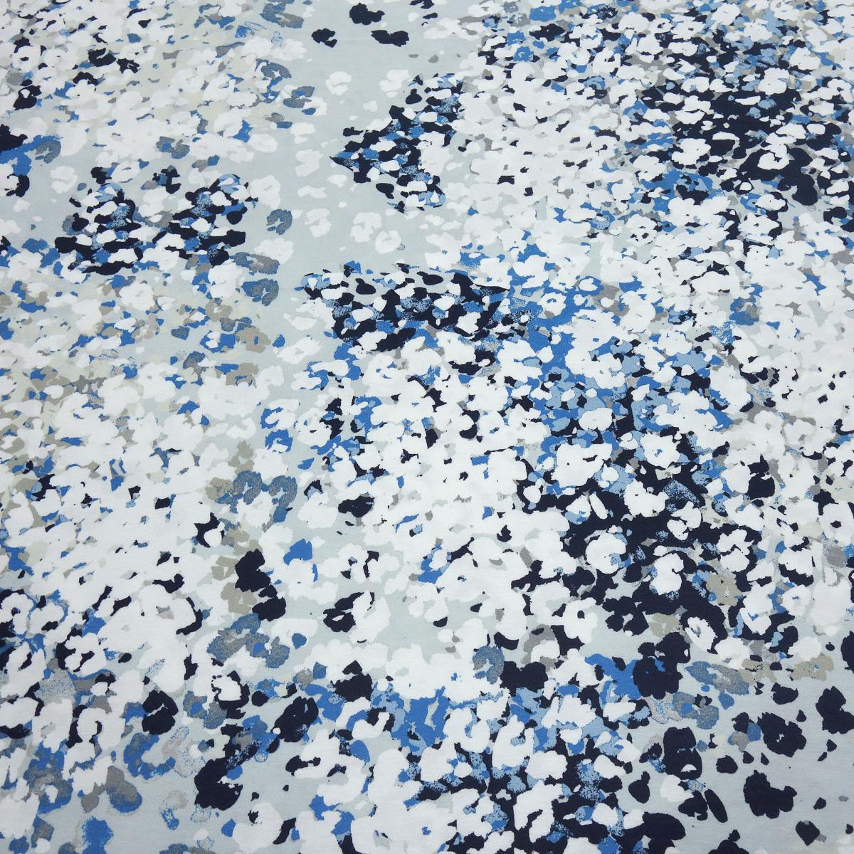 Viscose jersey fabric with abstract design in white, gray, blue, and navy blue. Clothing fabric. Children's fabric